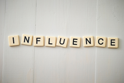 Letters spell the word influence.